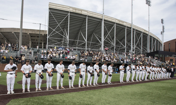 Photo of the Vanderbilt baseball team lined up with a gap for a missing player during a moment of silence for Donny Everett representing the 2016 season